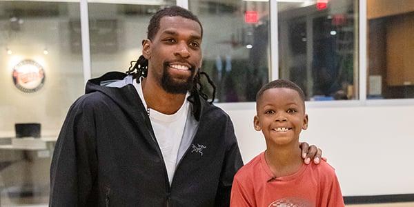 Picture of Minnesota Timberwolves Center Naz Reid and searching patient Cayden